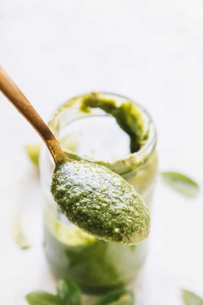 Spoon of Vegan Basil Pesto to show even more texture 